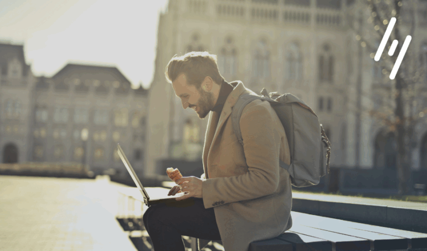 Man sitting with a laptop working internationally.
